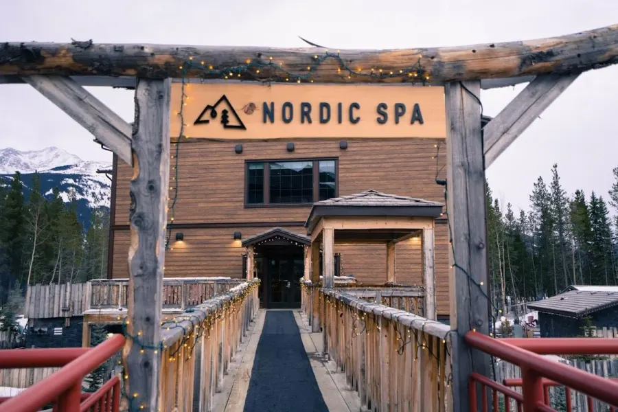 a wooden building with a sign on it